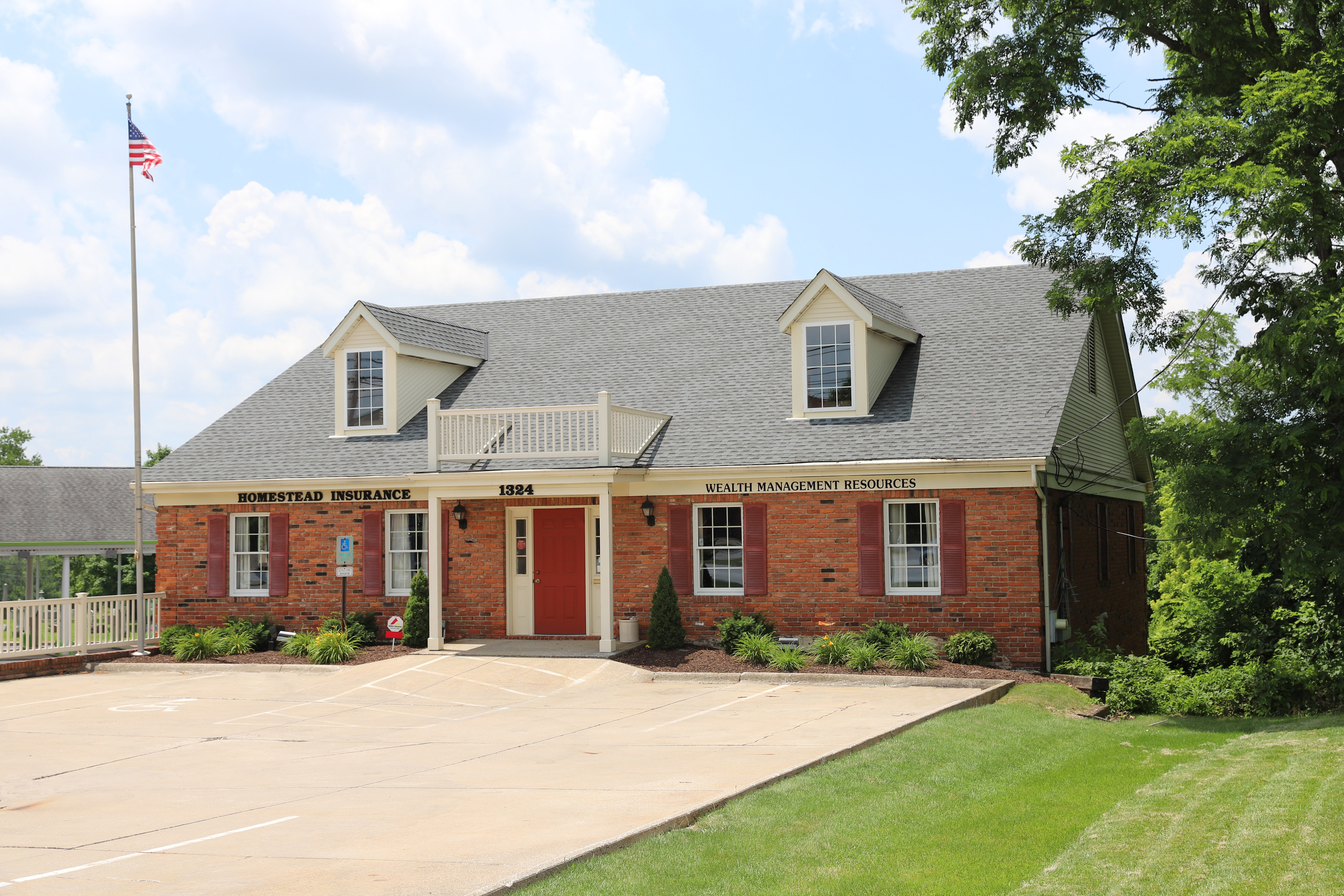 Brick house with a grey roof reciving home insurance quotes  in Brunswick