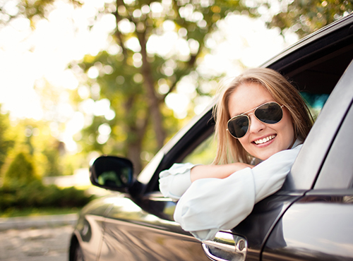 woman in sunglasses in a car with auto insurance in Fairlawn